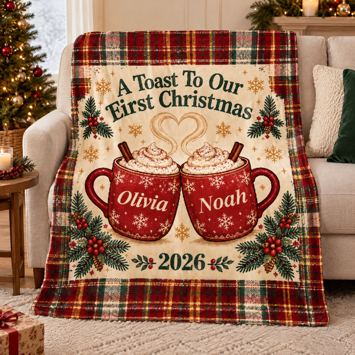 Personalized First Christmas Blanket draped over a cream sofa beside a lit Christmas tree, with two red cocoa mugs