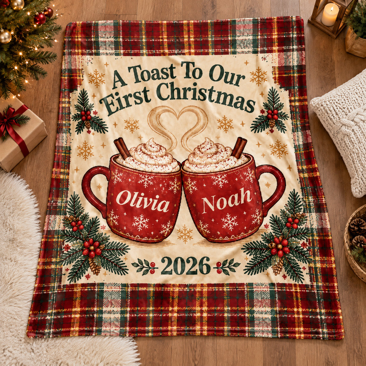 Personalized First Christmas Blanket laid flat on a wood floor with a gift, candle lantern and knit pillow nearby