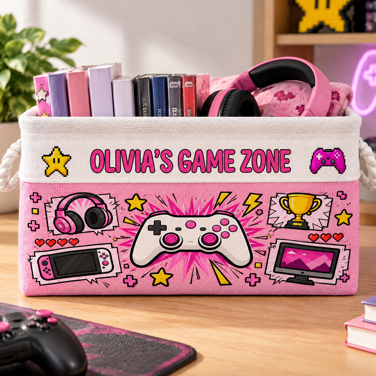 Personalized Game Zone Storage Basket in pink with headphones, game cases and a controller graphic on a wooden desk