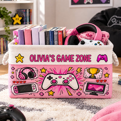 Personalized Game Zone Storage Basket in pink on a shaggy rug, holding game cases, headphones and a white controller