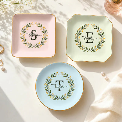 Monogram botanical wreath custom ceramic dish shown as pink, green and blue trio with Sophia, Emma and Taylor names