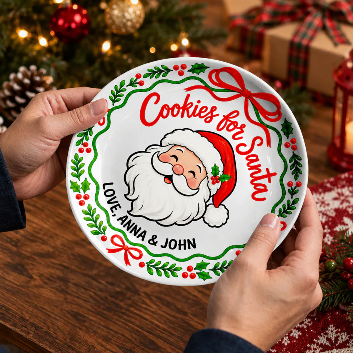 Personalized Cookies For Santa Ceramic Round Plate held in two hands near a Christmas tree and wrapped gift
