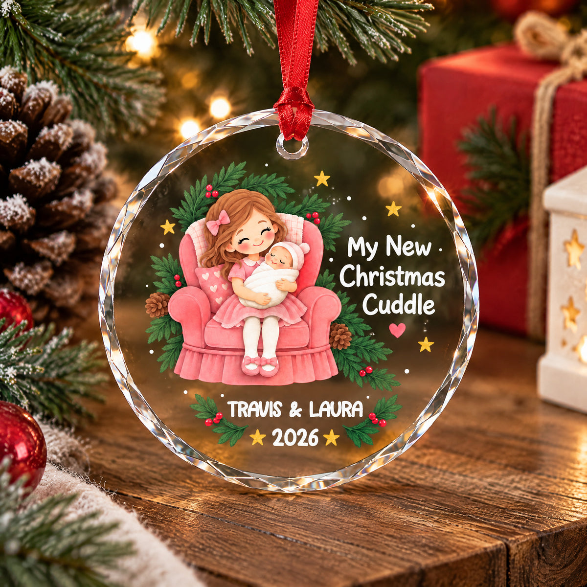 Personalized glass ornament My New Christmas Cuddle standing on wood with a red gift and star lantern behind