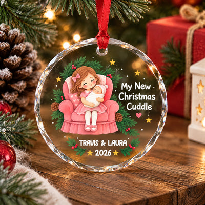Personalized glass ornament My New Christmas Cuddle standing on wood with a red gift and star lantern behind
