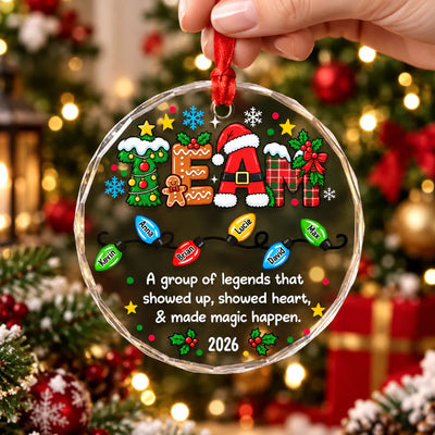 Personalized glass ornament custom team held by hand by a red ribbon in front of a lit Christmas tree