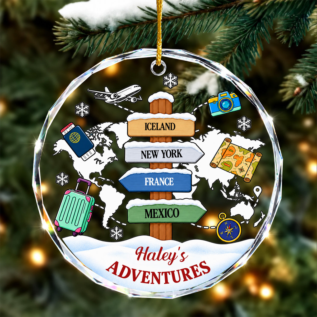 Personalized glass ornament adventure map hanging on a snowy pine branch, four destination signs on a world map