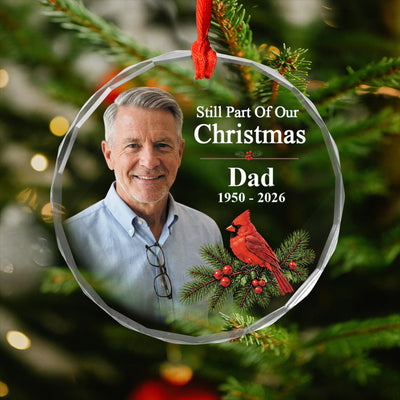 Personalized glass ornament custom photo hanging on a pine branch with a red ribbon, man's photo and cardinal shown