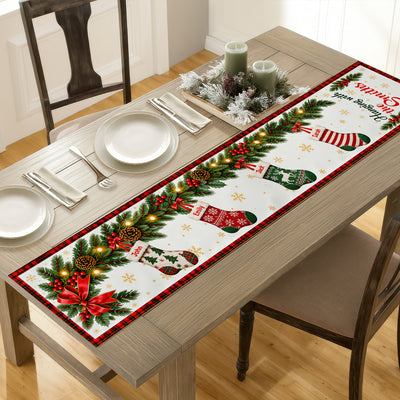 Custom family name stockings table runner at an angle on a rustic table with plates, candles and a wintry centerpiece