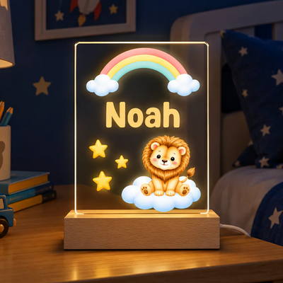 Personalized lion acrylic night light glowing with name Noah, rainbow and stars on a nightstand in a blue room