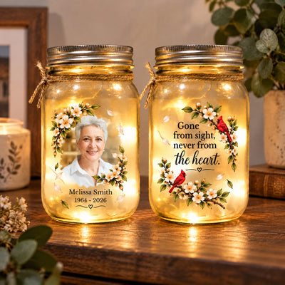 Personalized Mason Jar Light pair on a shelf beside a candle and plant, with flowers, cardinals and a portrait