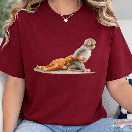 Person wearing a maroon t-shirt with a graphic of a monkey on a tortoise.