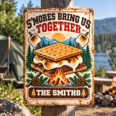 Personalized metal sign S'mores Bring Us Together mounted on a wooden post near a tent and fire pit