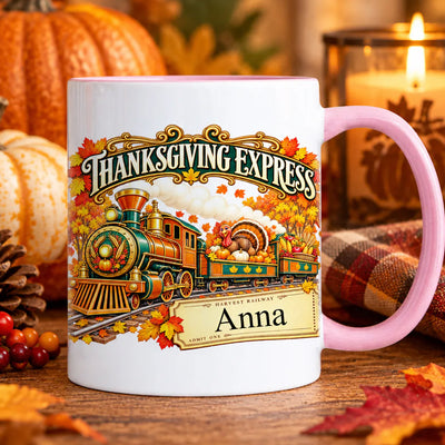 Thanksgiving Express Personalized Mug with pink handle on a wooden table with pumpkins and plaid cloth