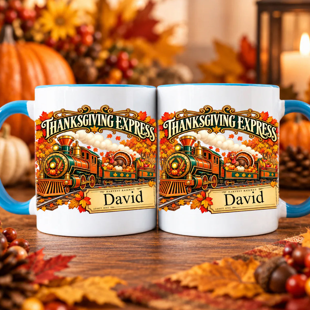 Thanksgiving Express Personalized Mug shown as a pair with blue handles among autumn leaves and pinecones