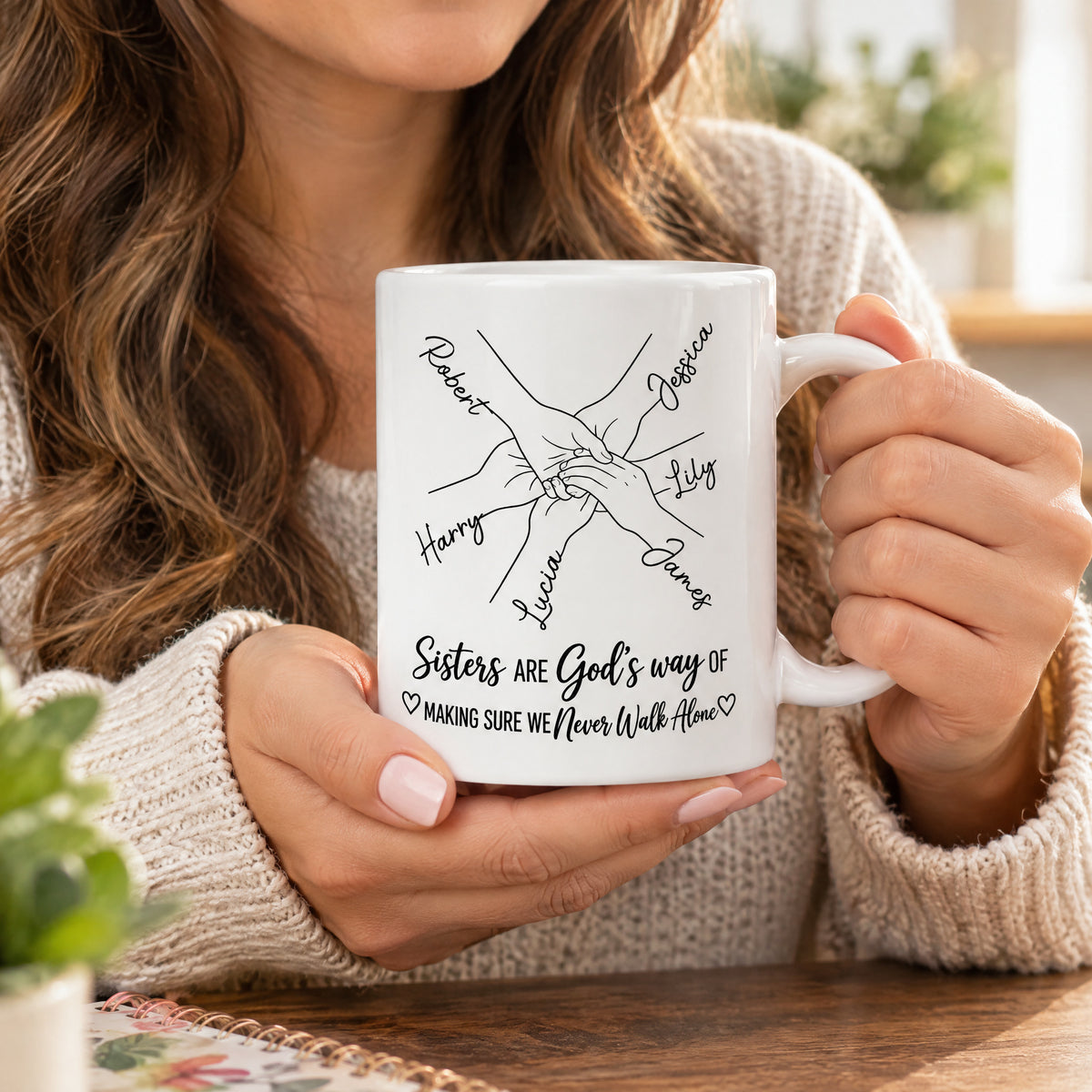 Personalized Sisters Name Mug held close up by a woman with long wavy hair in a cozy sweater