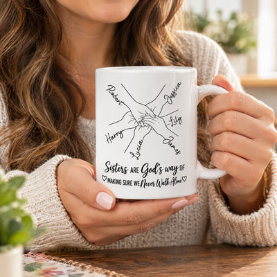 Personalized Sisters Name Mug held close up by a woman with long wavy hair in a cozy sweater