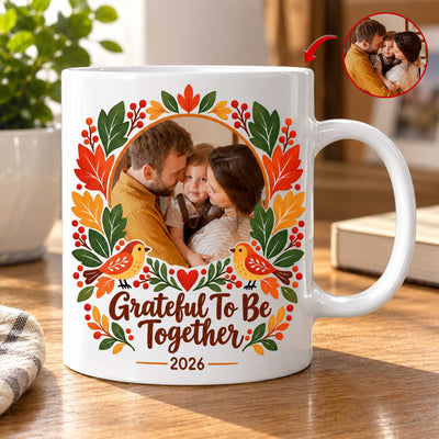 Thankful Together Personalized Photo Mug with a couple and child photo on a wooden table beside a plant