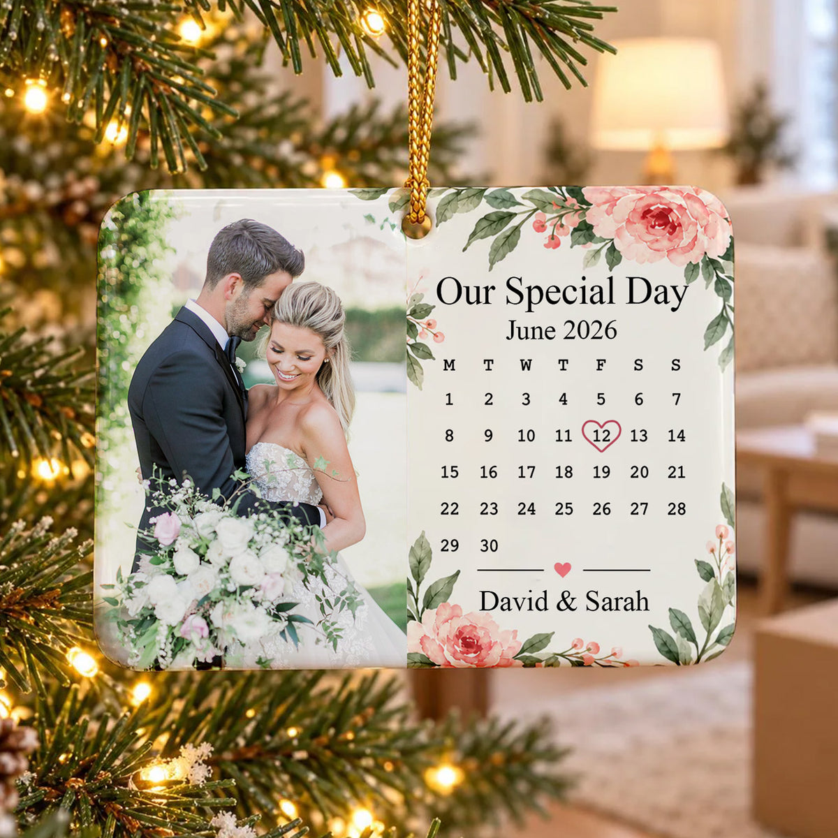 Personalized rectangular ceramic ornament hanging on a lit Christmas tree with a couple photo and June calendar