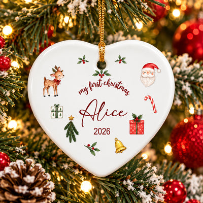 Personalized First Christmas Ceramic Ornament heart shape hanging on a snowy tree with red baubles and lights
