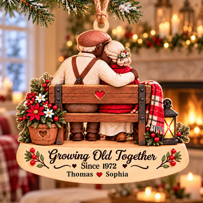 Personalized wooden ornament Growing Old Together hanging on a Christmas tree with red baubles and lights