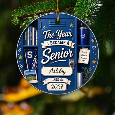 Personalized ceramic senior class ornament in blue locker design hanging from a pine branch with gold cord