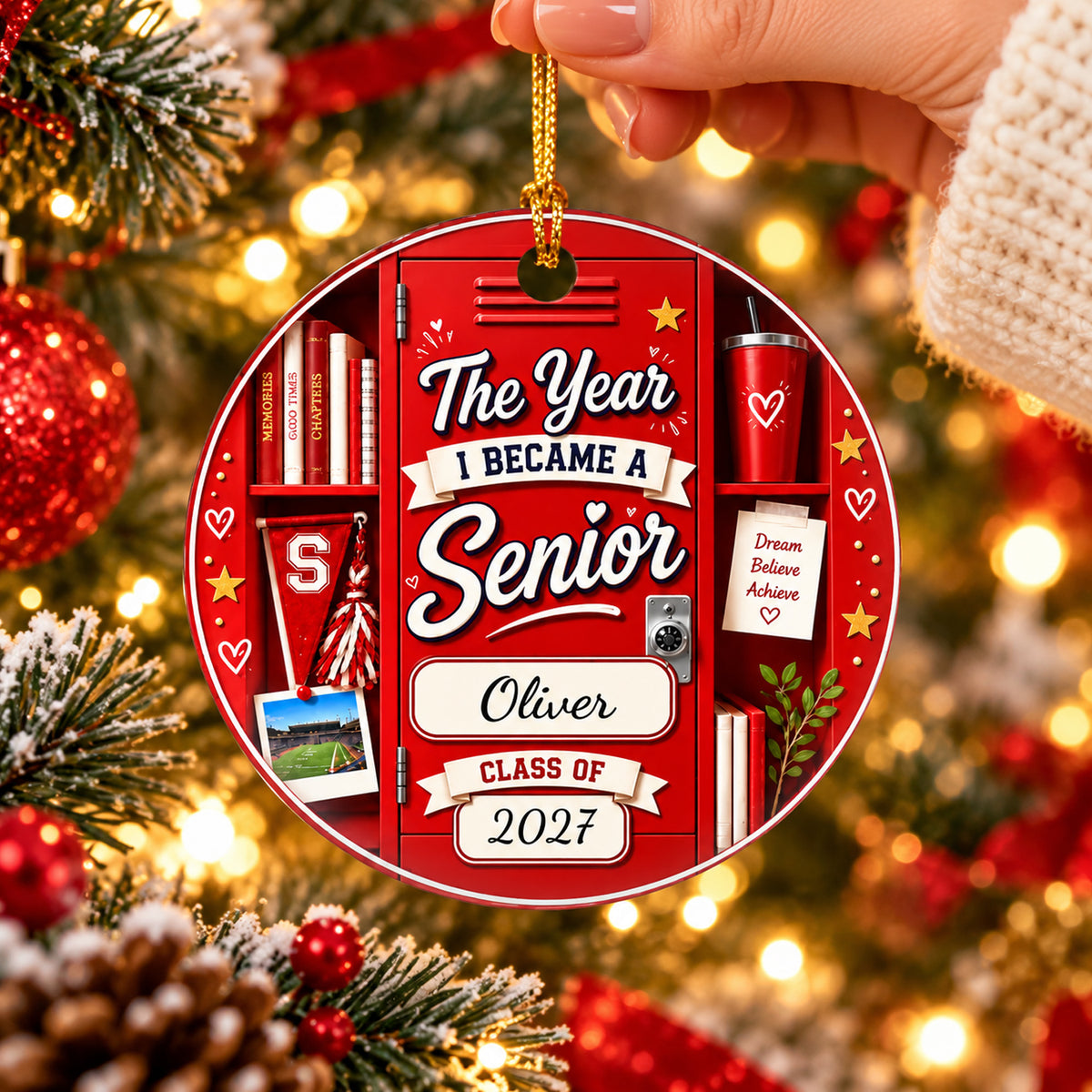 Personalized ceramic senior class ornament in red locker design held by hand near glowing tree lights