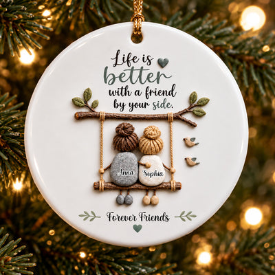 Personalized Ceramic Ornament Friendship Keepsake hanging on a lit pine branch, two pebble friends on a swing