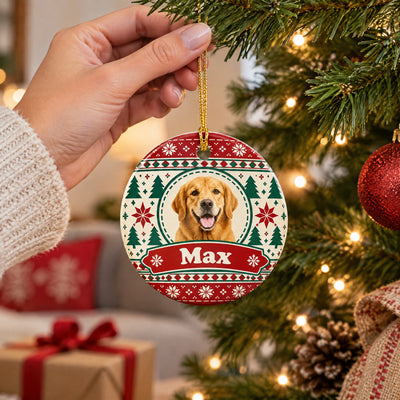 Personalized ceramic ornament custom photo name held by a hand by a tree, gift box and pillow behind