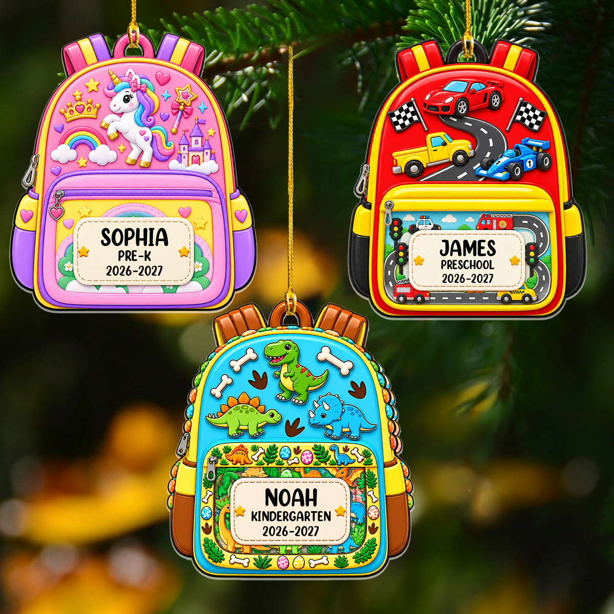 Personalized custom name backpack ornament, three designs hanging on a pine branch: unicorn, race cars and dinosaurs