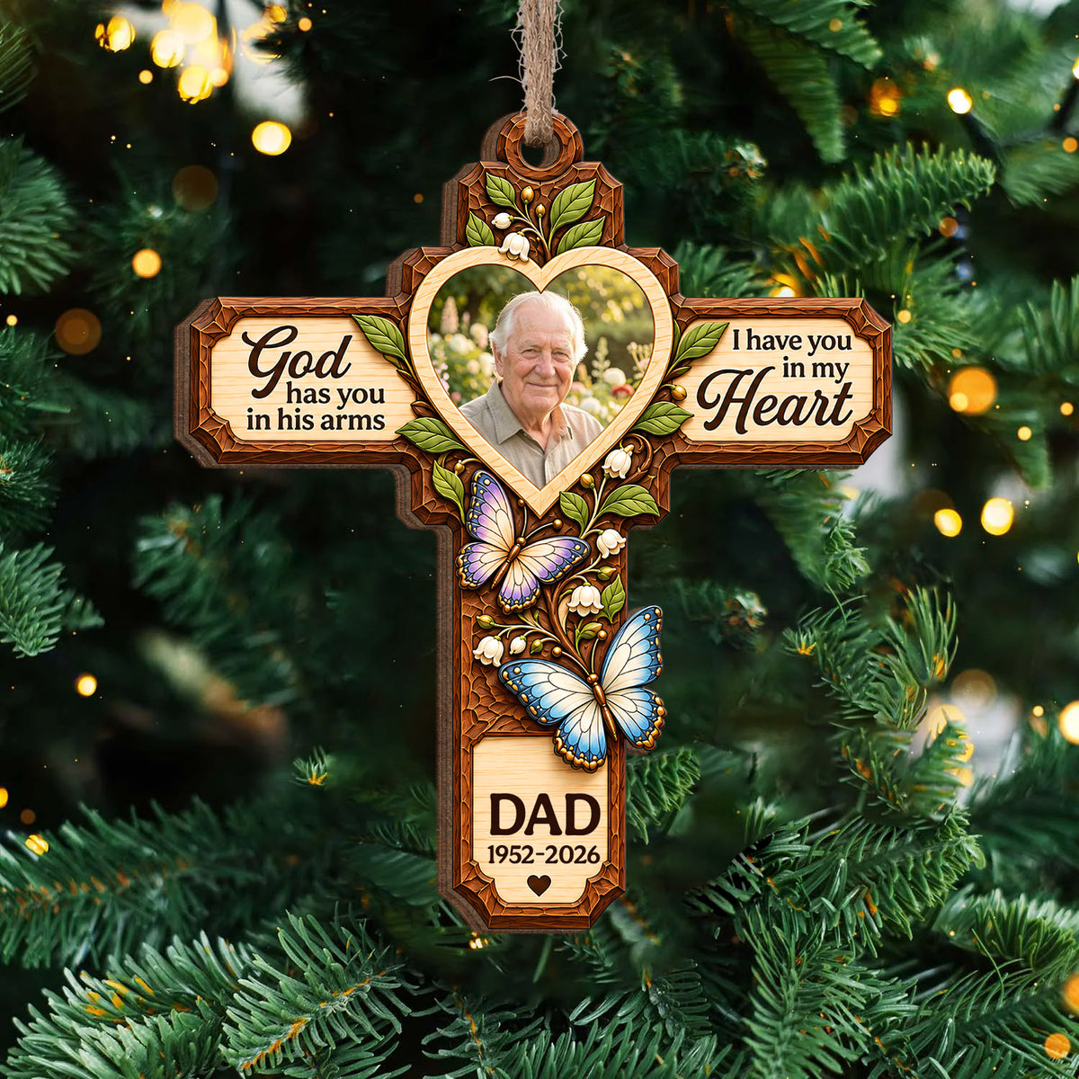 Personalized Memorial Wooden Ornament cross with heart photo and butterflies hanging on a lit Christmas tree
