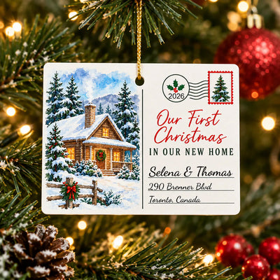 Personalized Rectangular Ceramic Christmas Ornament hanging from a pine branch with warm lights and a red bauble