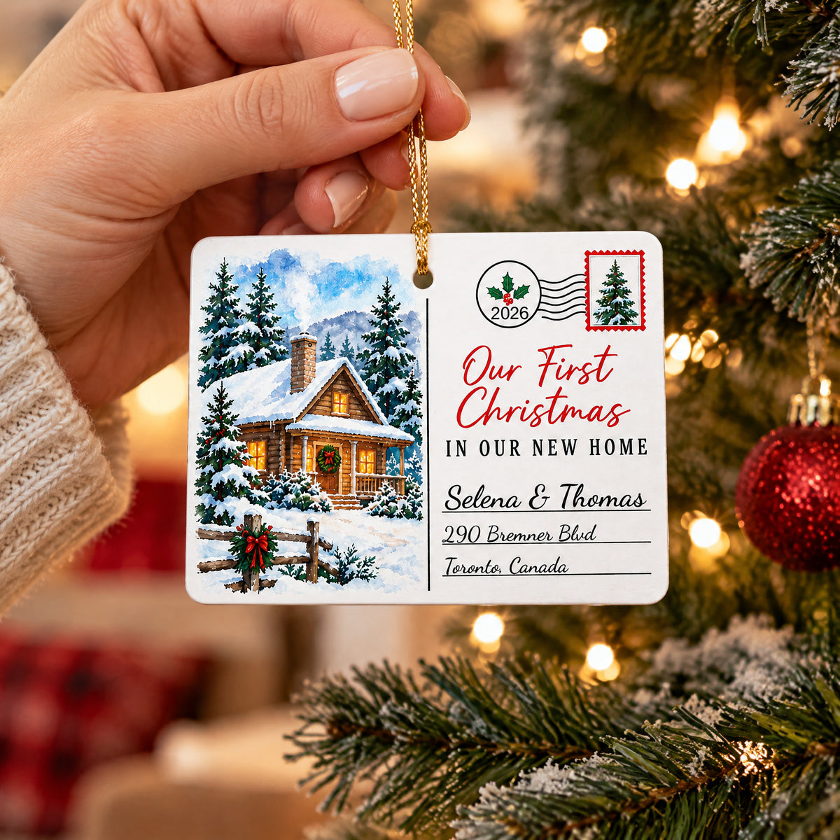 Personalized Rectangular Ceramic Christmas Ornament held in a hand by a snowy tree branch with a red bauble