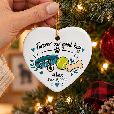 Personalized ceramic ornament Forever Our Good Boy heart with collar, ball and bone hanging on a lit tree