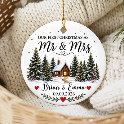 Personalized Ceramic Ornament Engaged Couple Gift round ornament resting on a cream knit blanket in a woven basket
