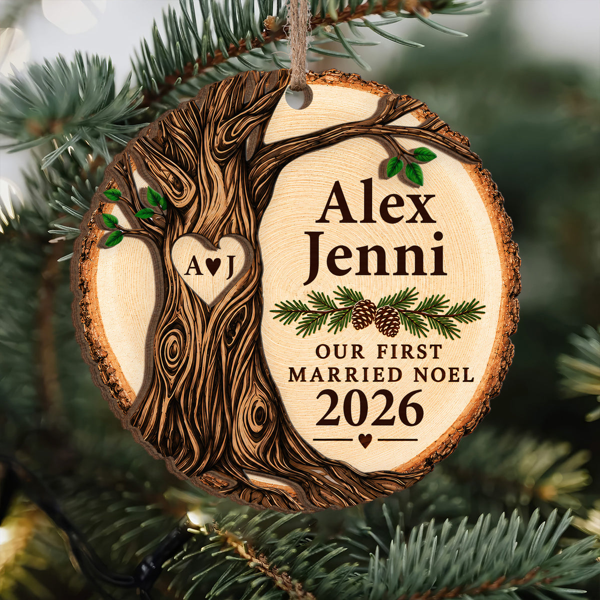 Personalized wooden ornament Our First Married Noel hanging on a pine branch with a carved tree and heart