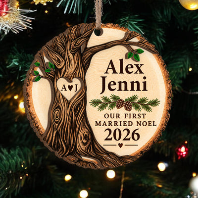 Personalized wooden ornament Our First Married Noel hanging on a pine branch with a carved tree and heart