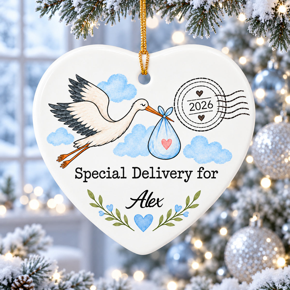 Personalized Stork Special Delivery Ceramic Ornament in blue hanging on a snowy branch with silver baubles