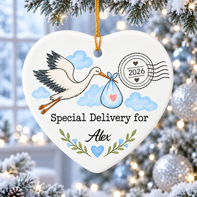 Personalized Stork Special Delivery Ceramic Ornament in blue hanging on a snowy branch with silver baubles