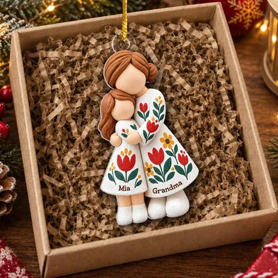 Personalized Grandmother Granddaughter Figurine Ornament lying in a kraft gift box with paper shred filling