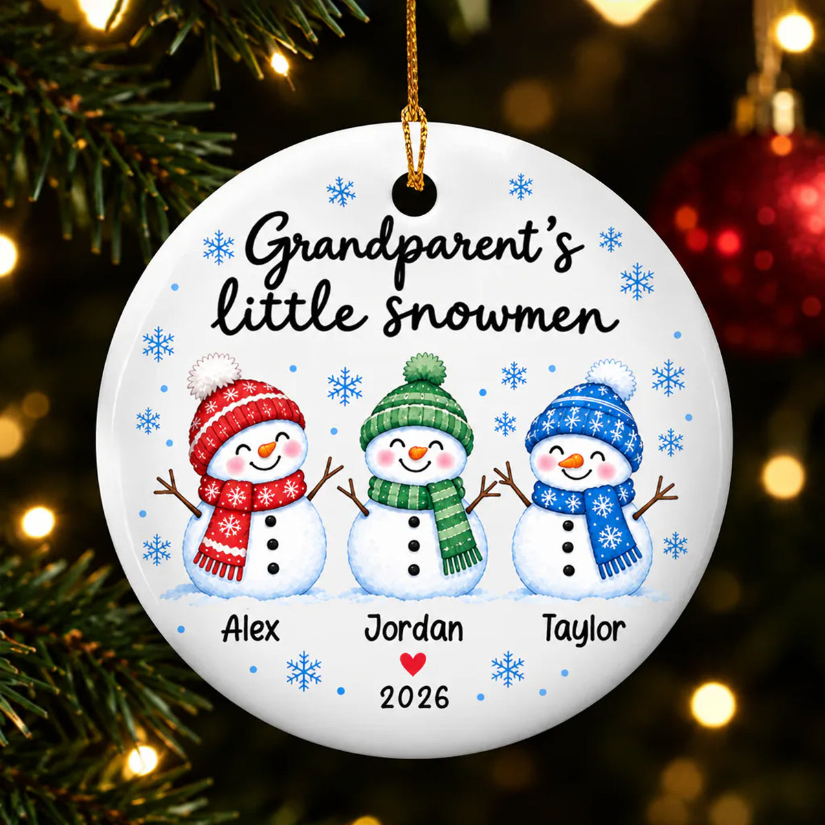 Personalized Grandparent's Little Snowmen Ceramic round ornament hanging on a tree with three snowmen and names