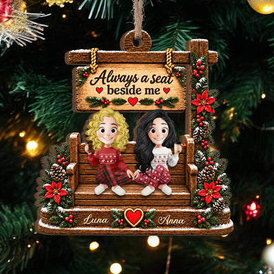 Personalized wooden ornament custom name showing curly blonde and long black haired friends, Luna and Anna, by tree lights