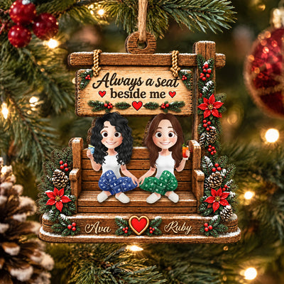 Personalized wooden ornament custom name with Ava and Ruby on a bench, framed by pine, red ornaments and a pinecone