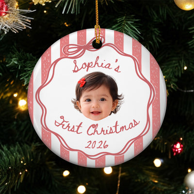 Personalized custom baby face Christmas ornament with red stripes, hanging on a lit Christmas tree