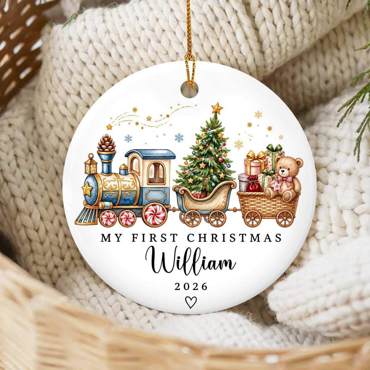 Personalized Custom First Christmas Ceramic Ornament with blue train design resting on cream knit blanket in a basket