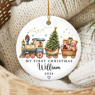 Personalized Custom First Christmas Ceramic Ornament with blue train design resting on cream knit blanket in a basket