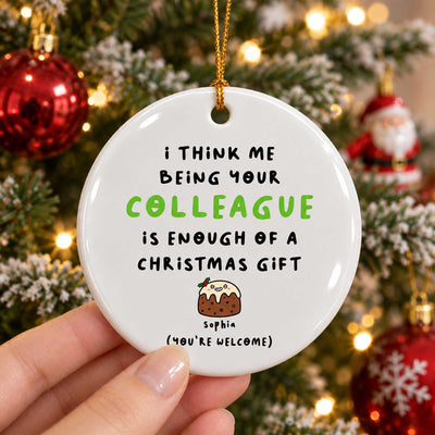 Personalized Colleague Christmas Gift Ceramic Ornament held in a hand, one pudding character, tree and Santa behind