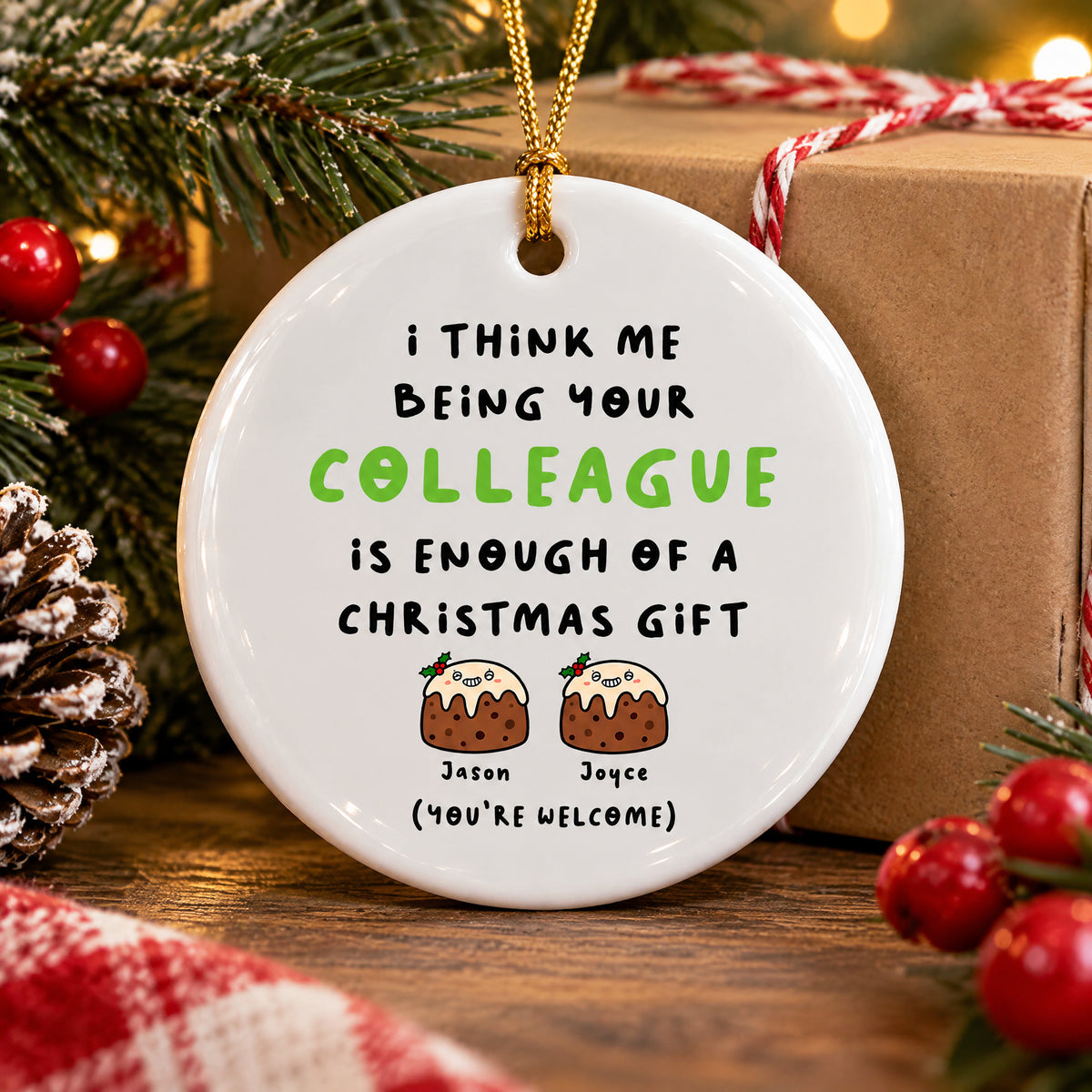 Personalized Colleague Christmas Gift Ceramic Ornament standing on a wooden table by a pinecone and a kraft gift box