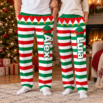 Personalized Elf Pajama Pants worn by a man by a Christmas tree, name Alex down the leg