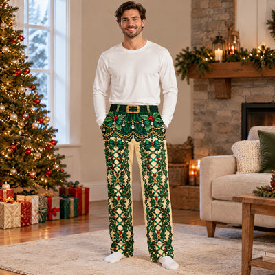 Funny holiday pajama pants in green holly print, full-length view of man smiling by a lit Christmas tree