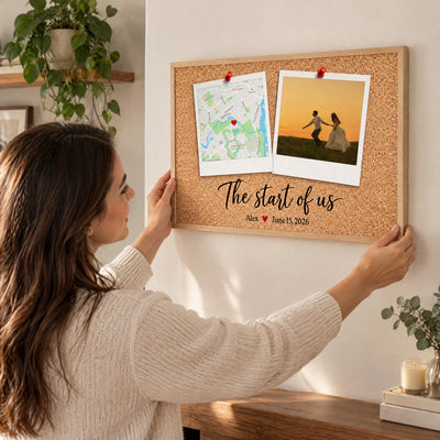 Personalized Polaroid Map and Photo Poster held up on a wall by a smiling woman in a knit sweater
